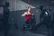 Slim fit muscular brunette woman exercise in gym, lifting weights and doing pilates. Picture with dark evening mood and film color