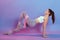Slim fitness woman stretching body in upward plank pose, doing reverse planking exercise with resistance elastic band indoor,