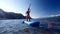 Slim girl in bikini rows paddle board on open ocean