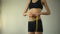 Slim girl measuring waist with tape-line, showing ok, anorexia as mental illness