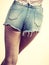 Slim girl wearing denim shorts back view