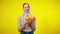 Slim joyful redhead woman juggling oranges at yellow background. portrait of laughing positive Caucasian millennial