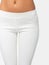 Slim legs of a young girl in leggings on a white background. Concept of a fit figure and the absence of problem areas