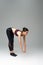 slim, sportive woman doing forward bend