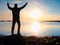 Slim sportsman on nord sea coast. Hiker open arms to the sunrise stand at seaside boulder