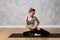 Slim sporty woman doing yoga pose against texturized background