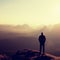 Slim tourist on the sharp peak of rock in rock empires park is watching over the misty and foggy valley to Sun