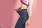 Slim waist of young female in big jeans