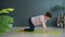 Slim woman doing yoga indoors in wellness center on mat focused on bodycare