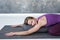 Slim woman doing yoga for spine and rest lying in Child Pose, Balasana Posture