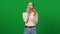 Slim woman eating delicious unhealthy food on green screen. Portrait of happy smiling Caucasian eater biting and chewing
