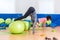 Slim young Caucasian women exercising doing stability ball roll outs with pull-in or handstand in a gym