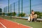 Slim young girl athlete tennis player is on the open tennis court in summer