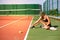 Slim young girl athlete tennis player is on the open tennis court in summer