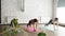 Slim young ladies are doing side plank pose Vasisthasana while practicing yoga in modern studio. Gracious women and