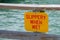 SLIPPERY WHEN WET dock sign
