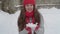 slo-mo authentic cute happy beautiful young woman with long flowing hair in red hat and scarf looking at camera with