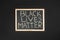 Slogan black lives matter written by hand on the chalkboard. protest against racism and concept of equal rights