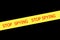 Slogan STOP SPYING on yellow tape