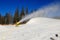 The slope of Bukovel ski resort with working snow machine