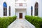 Slope corridor in a white house with arched window