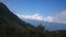 On the slope of a high mountain with a green slope and a top in clouds and fog. Sports and tourist base in the mountains. Krasnaya