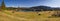 Slope with some wooden barns, view to lake Geroldsee and Karwendel alps. bavarian landscape panorama