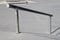 Sloped metal rail for grind tricks in an empty concrete skatepark