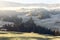 Slopes of Seiser Alm plateau covered with morning mist and the first frosts