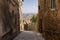 Sloping alley leading to iconic Tuscanian landscape