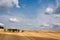 Sloping field with impressive sky and clouds