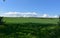 Sloping Grass Field Under Blue Skies in England