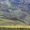 Sloping hill against a mountainside