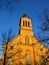 Slovak evangelical Augsburg church in Modra in evening spring sunshine, clear blue skies, front facade with tower clock visible.