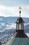 Slovak twin cross placed on baroque building of central church of calvary in Banska Stiavnica, Slovakia, snow covered hills i