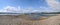 Slovakia lake with blue water and sand beach, white clouds on blue sky