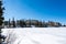 Slovakia: Strbske pleso resort, view of frozen lake in winter and hotel resort above. Blue sky.