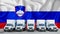 Slovenia flag in the background. Five new white trucks are parked in the parking lot. Truck, transport, freight transport. Freight