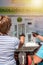 Slovenia, Isola. August 29, 2012. A woman buys milk in the machine for street sale of milk. Milk in bottles and issued by the mach
