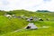 Slovenia velika planina big plateau, agriculture pasture land near city Kamnik in Slovenian Alps. Wooden houses on green land