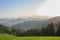 Slovenian breathtaking landscape at sunrise with Julian Alps and charming little church of Sveti Tomaz Saint Thomas on a hill,