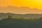 Slovenian breathtaking landscape at sunrise with Julian Alps and charming little church of Sveti Tomaz Saint Thomas on a hill,