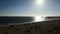 Slow Aerial Dolly shot of the Huntington Beach Pier and Beach shot into the setting sun.