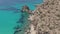 Slow Aerial Flight above Greek Island Milos Turquoise Blue Ocean with Rocky Cliff Coast