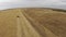 Slow Aerial shots of harvester at work on farm