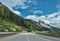 Slow curve on the Coquihalla highway with massive rocky mountain view