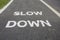 SLOW DOWN painted on the bike lane