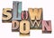 Slow down word abstract in wood type