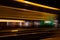 Slow exposure of a passing tram at night with light trails.