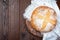 Slow fermentation no knead Classic Boule bread, round loaf on a wooden board with white cloth, horizontal, top view, copy space